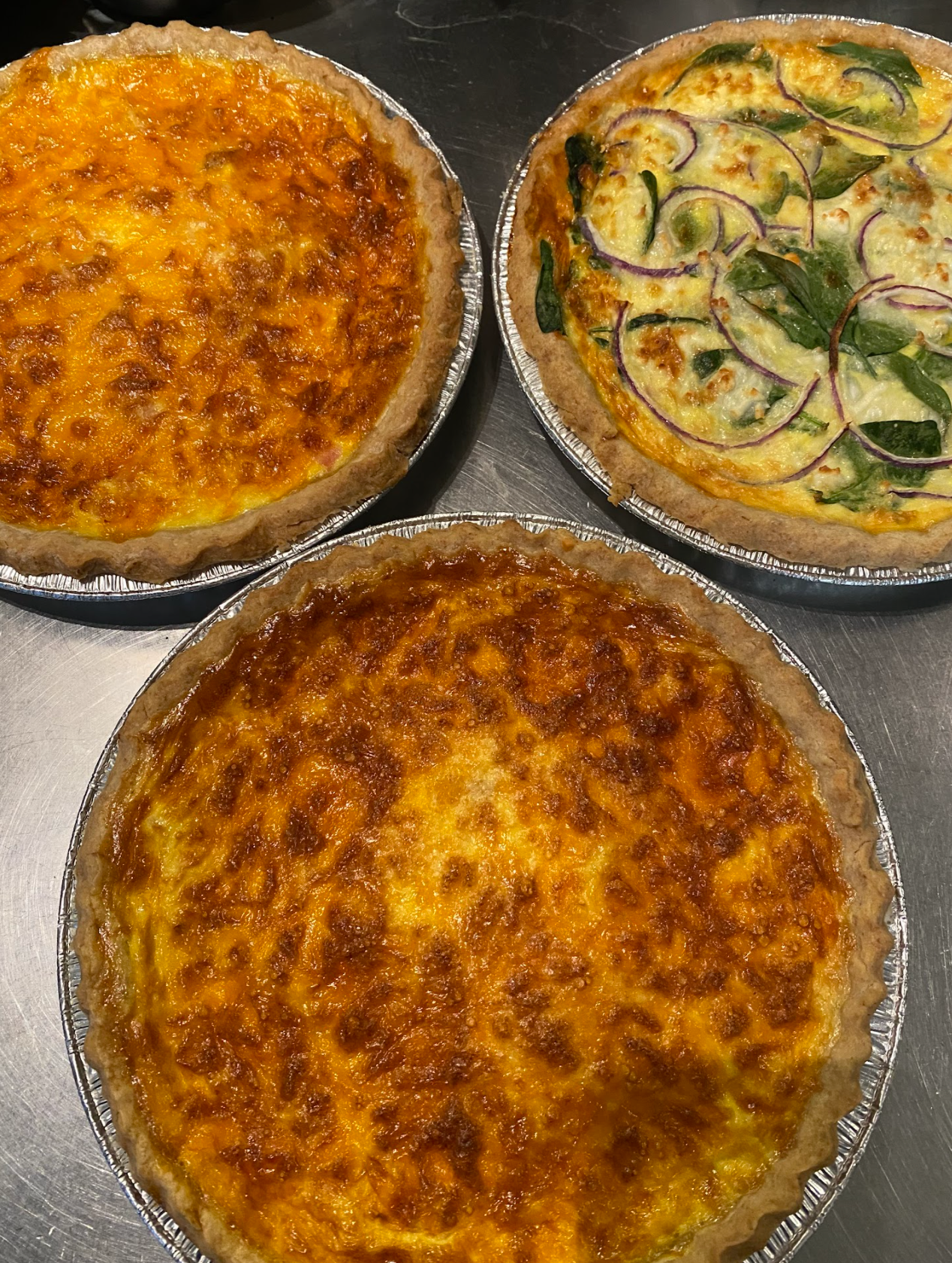 Two Ham & Cheddar full sized quiches, with a Spinach, Feta & Red Onion Quiche as well.